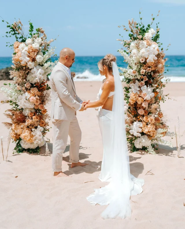 Planning a wedding under the sun? ⁠
⁠
Whether you’re dreaming of barefoot vows on the sand or a garden soirée under the stars, outdoor weddings come with their own unique styling challenges.⁠
⁠
Today on Polka Dot Wisdom, Vanessa from @wedeventcreators shares her expert tips on how to beat the heat without compromising on style – think breezy fabrics, wind-proof florals, chilled drinks, and clever shade solutions.⁠
⁠
Tap the link in bio to discover the trends that’ll keep your celebration cool, calm, and utterly chic.⁠
⁠
Photography: @theevokecompany⁠ / Planning & Coordination: @wedeventcreators ⁠/ Rentals: @socoeventhire ⁠/ Florist: @theflowerpursuit⁠
⁠
[Image description: A bride and groom stand barefoot on a sandy beach, holding hands during their wedding ceremony. The bride wears a modern, strapless white gown with a long, flowing veil, while the groom is dressed in a light beige suit and no shoes. Behind them, two large, asymmetrical floral arrangements featuring neutral and warm-toned flowers—such as white orchids, beige roses, dried foliage, and pampas grass—frame the ocean backdrop. The clear blue sky and crashing waves complete the serene and romantic coastal setting.]⁠
⁠
#PolkaDotWedding #FeelGoodWeddings #AustralianWeddings #AustralianWedding #PolkaDotWisdom #WeddingPro #WeddingVendor #WeddingProfessional #WeddingInterview #BeachWedding #DestinationWedding #OutdoorWedding #SummerWedding ⁠
⁠