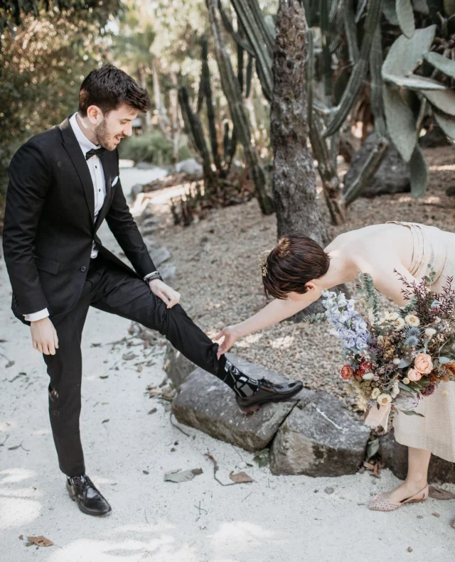 May the fourth be with you today. Even in the subtle ways, like Ashley wearing his Darth Vader socks to his and Tanée's wedding!⁠
⁠
Photographer: @cloudcatcherstudio⁠
⁠
[Image description: Ashley has his foot elevated so Tanée can see his Darth Vader socks under his classic black tux. She's wearing a glittering gold tea-length dress, holding a bouquet full of soft blues, peaches and purples.]⁠
⁠
#PolkaDotWedding #MayTheFourth #MayTheForce #MayTheForceBeWithYou #FeelGoodWeddings #AustralianWeddings #AustralianWedding #WeddingStory #WeddingStories #WeddingMemories #WeddingInspiration #WeddingInspo #RealWedding