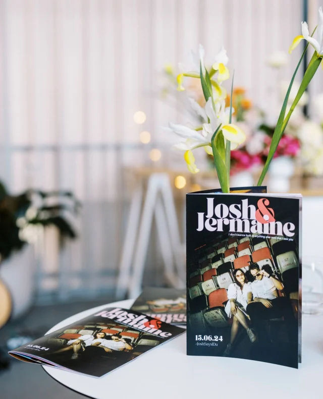 A trend we’ve been loving lately? Couples creating their own wedding newspapers and magazines! A wedding like Jermaine and Josh's day deserved its own shoutout. ⁠
⁠
Jermaine took the idea to the next level, packing their magazine with photos from their pre-wedding shoot in Singapore, fun facts, intros to the wedding party, family shoutouts, and even a custom crossword puzzle for guests to enjoy.⁠
⁠
See all the sweet, cheeky moments at the link in bio!⁠
⁠
Photographer: @jonong⁠
⁠
[Image one description: Sitting on a white round table at the entrance to the ceremony space is a pile of magazines titled "Josh & Jermaine" with a cool shot of the couple on the cover. One magazine stands up and surrounds a couple of lilies.⁠
⁠
Image two description: The newlyweds themselves are sitting on a metal staircase, holding their magazines open and peaking out at each other over the tops.]⁠
⁠
⁠
#PolkaDotWedding #FeelGoodWeddings #AustralianWeddings #AustralianWedding #WeddingInspiration #WeddingInspo #WeddingDetails #UniqueDetails #WeddingDetail #NewlywedMagazine #WeddingMagazine #NewlywedNewspaper #WeddingNewspaper
