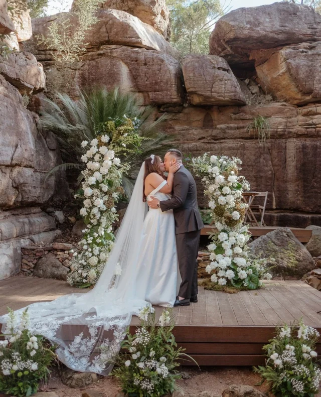 Angeline and Josh turned their love story into a three-day celebration at Kangaroo Valley Bush Retreat, and it was pure perfection.⁠
⁠
From a heartfelt proposal to a wedding weekend filled with family, culture, and fun, their day reflected everything that mattered most. Think soft whites and sage greens, heartfelt DIY details, a choreographed first dance, and the meaningful Filipino veil and cord ceremony.⁠
⁠
Tap the link in bio to read their full story today on Polka Dot You! ⁠
⁠
Photographer: @sj.gonzaga / Cinematographer: @sj.gonzaga / Venue: @kangaroovalleybushretreat / Catering: @rabbitandco_brisbane / Catering: @wanderingwoodfireoven / Beverages: #BomaderrySuperCellar / MC: @jmg_coaching / Makeup Artist: @margaretalbia / Hairstylist: @houseofcolour_bylisa / Ceremony Officiant: @celebrant_beverly / Flowers: @rainfloraldesign / Ceremony Musicians: @danniandsteph / DJ: @momentsandmemoriesmelb / Lighting: @momentsandmemoriesmelb / Fireworks: @momentsandmemoriesmelb / Photo Booth: @momentsandmemoriesmelb / Content Creator : @socialssydneycontent / Bride's Dress: #EssenceOfAustralia / Bride's Shoes: @jimmychoo / Groom's Attire: @institchu / Groom's Shoes: @louisvuitton / Bridesmaid Dresses: @becandbridge / Bridesmaid Shoes: @novoshoes / Wedding Planner: #KayleSee / On Site Content Creator : keina.co / Wedding Nails: @cjartistry⁠
⁠
[Image description: A bride and groom share their first kiss as a married couple at an outdoor ceremony set against dramatic sandstone cliffs. The bride wears an elegant off-the-shoulder ivory gown with a long veil featuring lace detailing, while the groom is dressed in a classic dark suit. They are framed by lush white floral arrangements and greenery, creating a timeless and romantic setting.]⁠
⁠
#PolkaDotWedding #TheTraditionsIssue #FeelGoodWeddings #WeddingTraditions #MulticulturalWedding #FilipinoWedding #OutdoorWedding #ModernWedding #CulturalWeddings #InclusiveWeddings #WeddingInspo #AustralianWeddings #AustralianWedding #WeddingStory #WeddingStories #WeddingMemories #WeddingInspiration #RealWedding